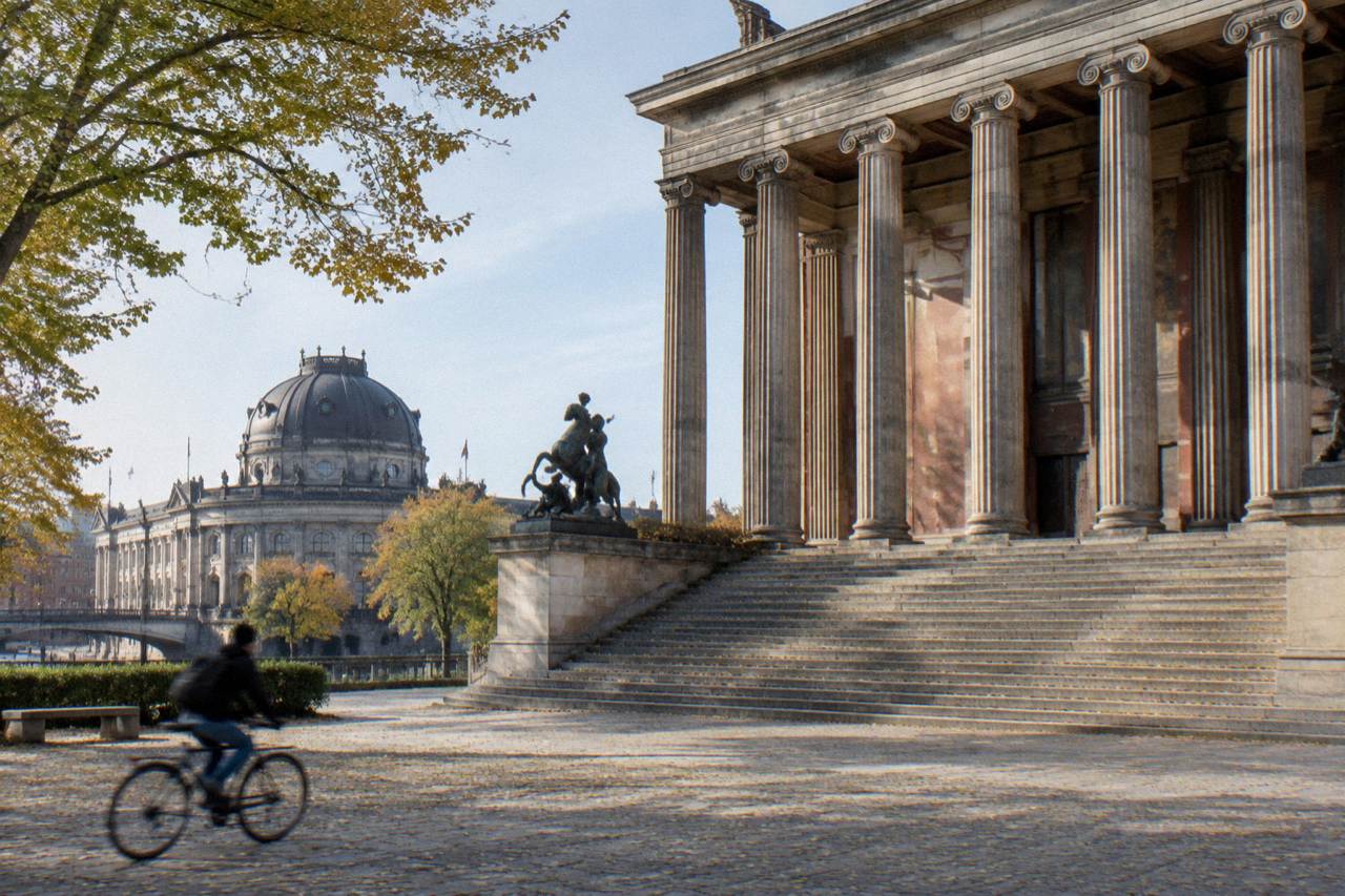 Exterior of a Berlin museum building with tall columns, wide steps and an empty forecourt