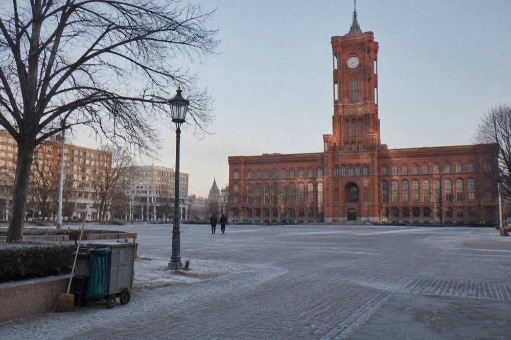Open public square in Berlin with historic facades and a cleared central area