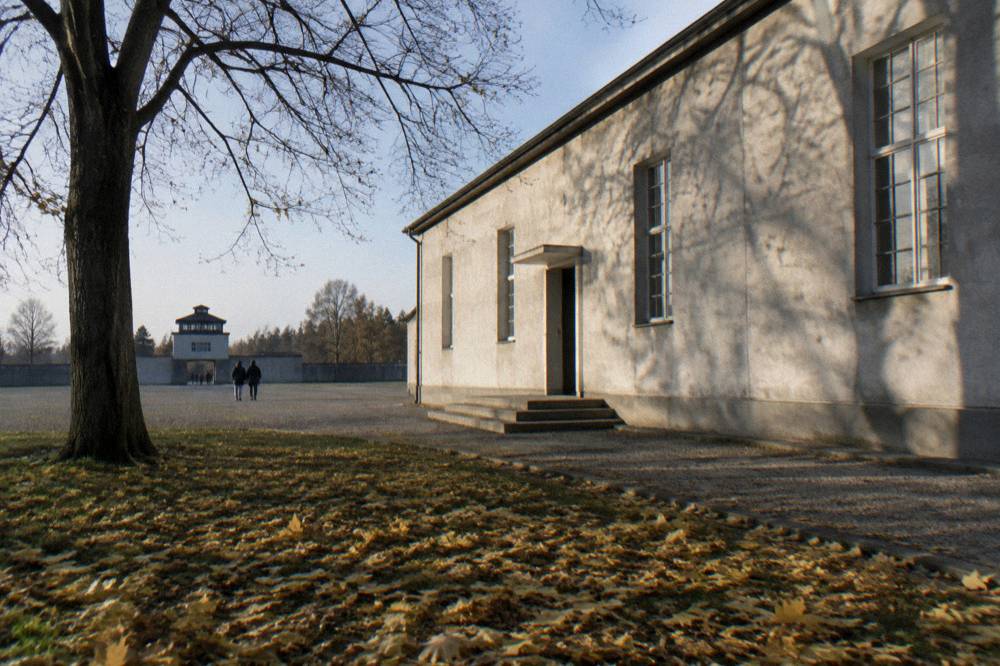 Exhibition building exterior at a memorial site under a wide autumn sky