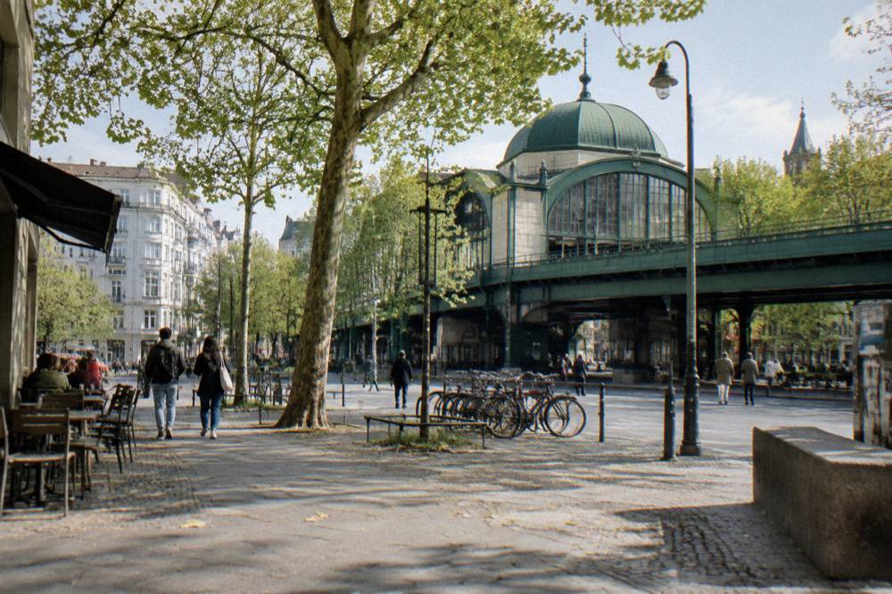 Berlin city street with U-Bahn entrance and apartment facades in daylight