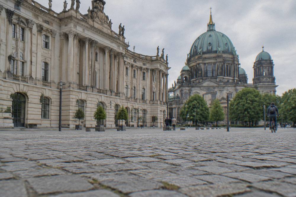 Cobblestone square in central Berlin with historic facades under a clear sky