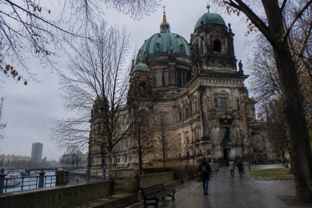 Close view of Berlin Cathedral's stone facade and central dome from the open ground on Museum Island