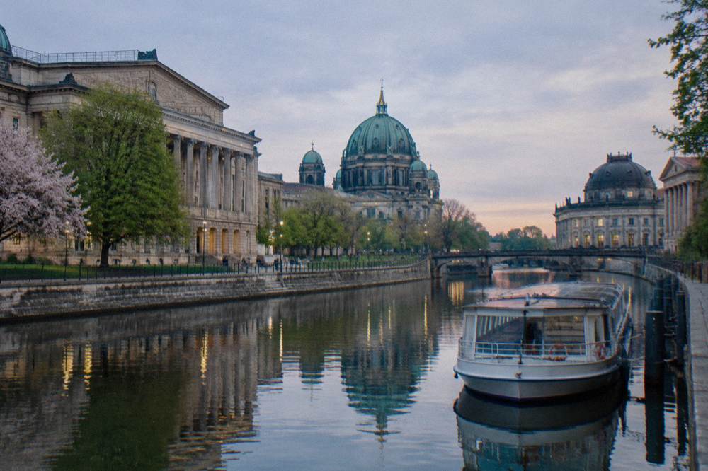 Wide view of Museum Island with Berlin Cathedral's dome and the river in the evening light