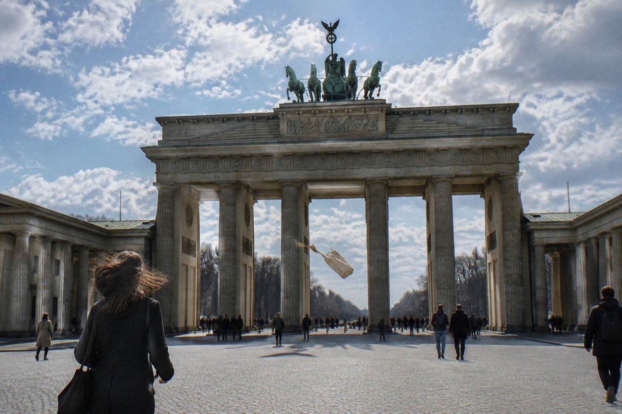 Wide view of Pariser Platz in Berlin with the Brandenburg Gate standing at the centre of the open square