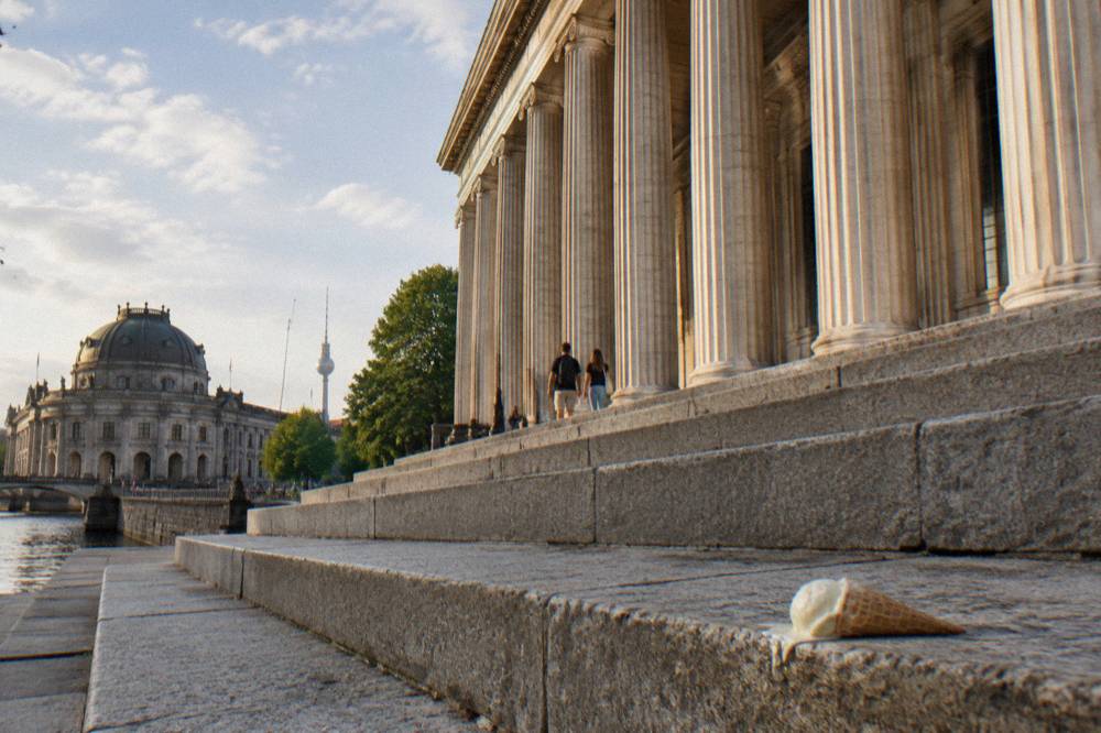 Museum building facade with wide stone steps and columns in daylight