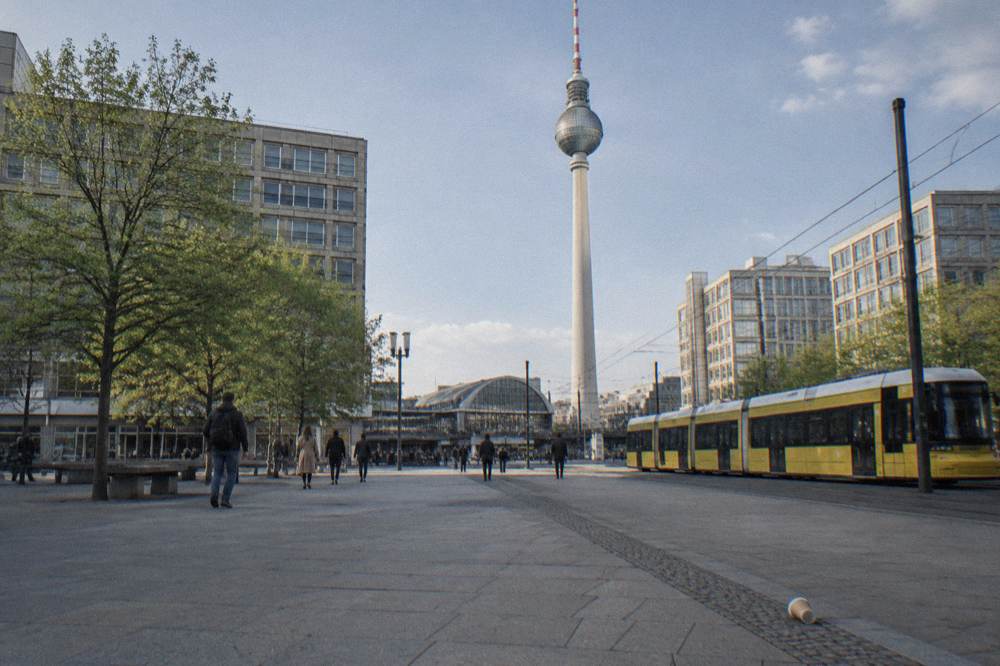 A small walking tour group gathered at a Berlin meeting point on a city square