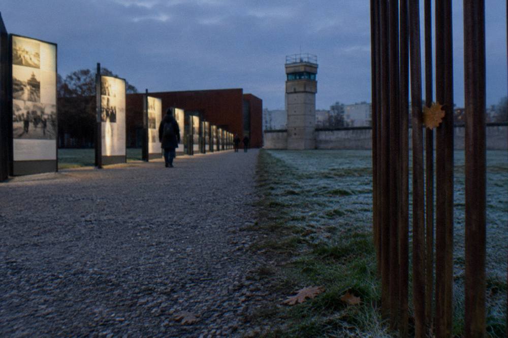 Preserved section of the Berlin Wall border strip with informational panels along Bernauer Strasse