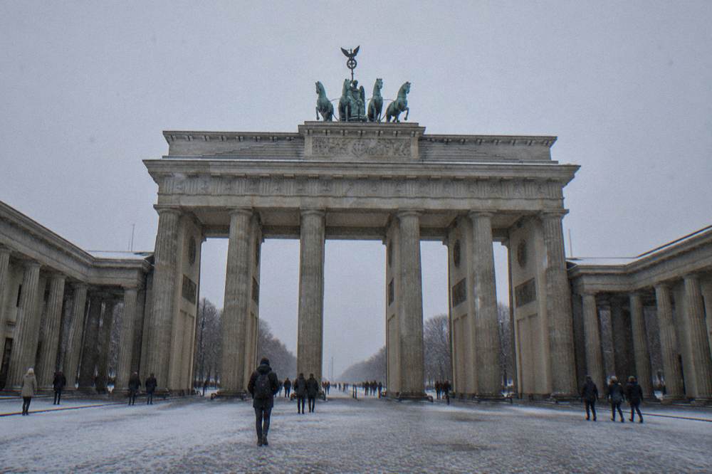 The columns of the Brandenburg Gate framed by open sky above Pariser Platz