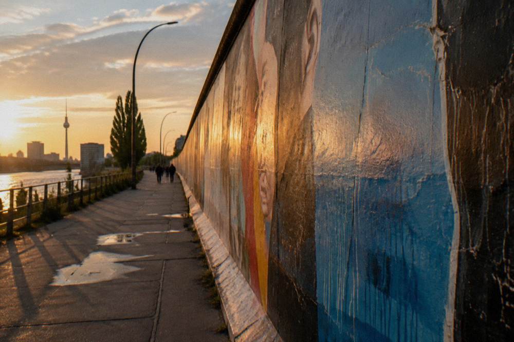Sunlight falling across the painted surface of the old border wall at the East Side Gallery