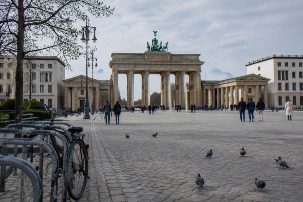 Wide plaza in central Berlin with historic buildings under a pale sky