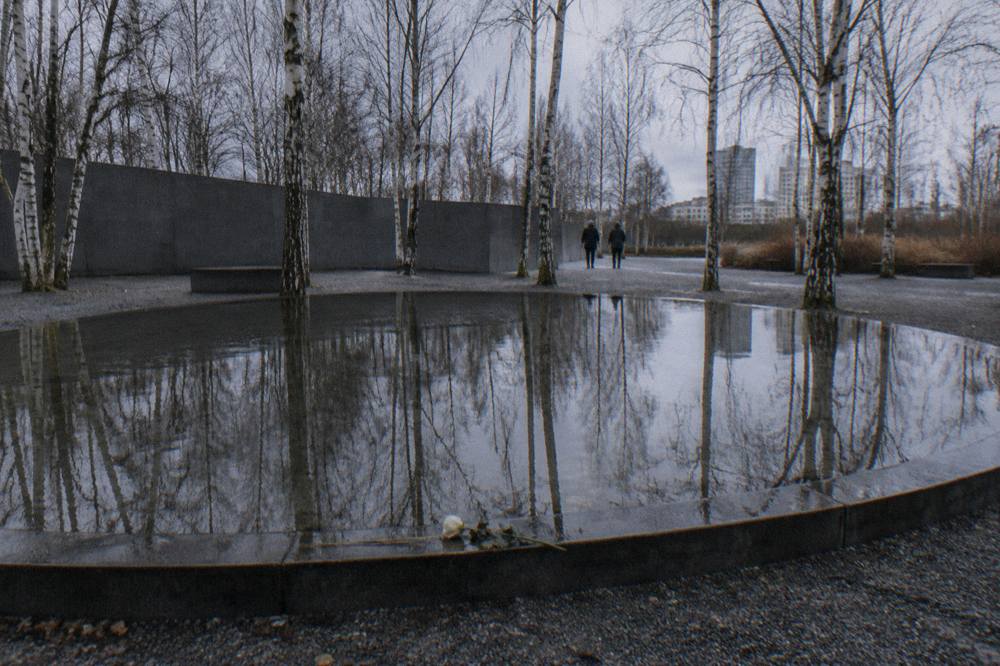 Empty exhibition hall inside a Berlin memorial museum with information panels along the wall