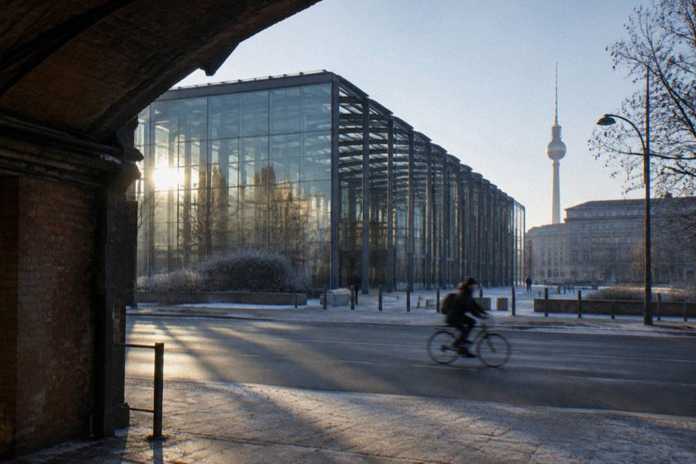 Reflecting pool at the Memorial to the Sinti and Roma in Berlin surrounded by dark stone walls
