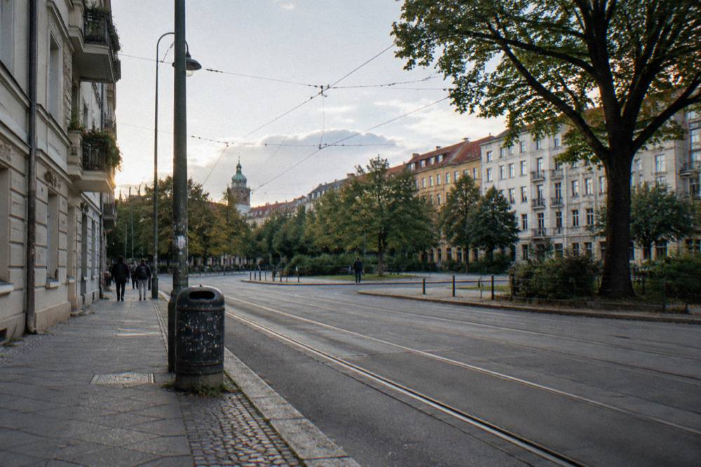 Guide speaking to a gathered walking tour group on a Berlin square
