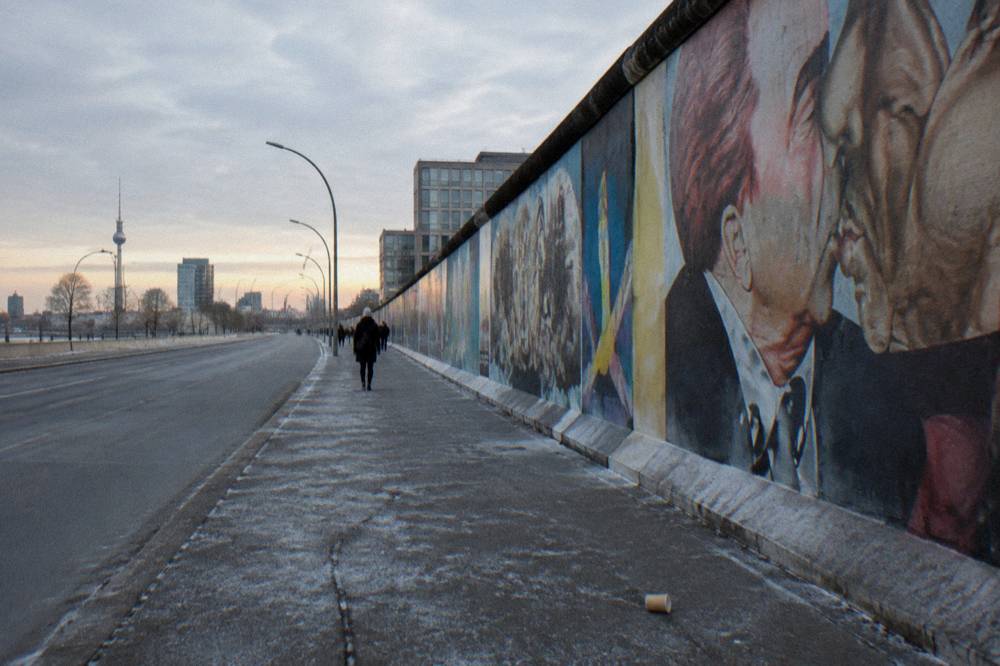 A wide city street with a preserved border installation and open sky above