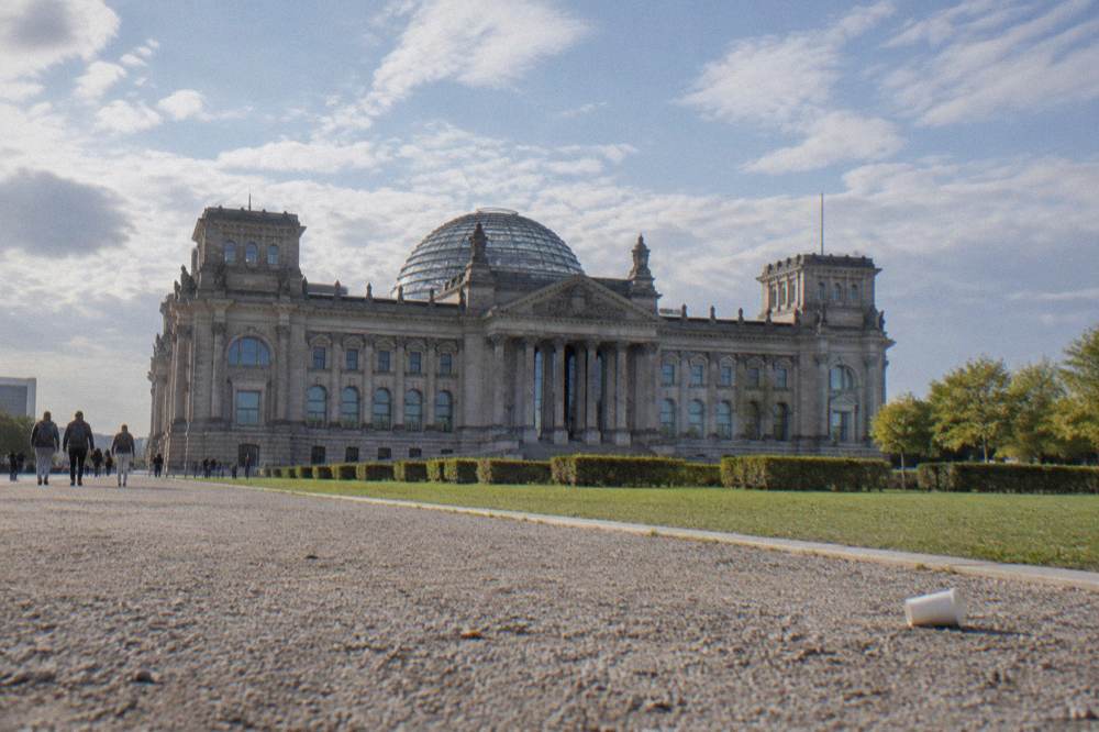 The Reichstag building with its glass dome seen from the open ground in front of it