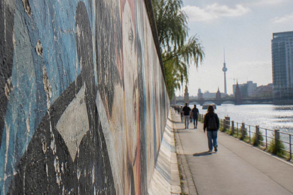 Close view of colorful painted mural panels along the East Side Gallery wall
