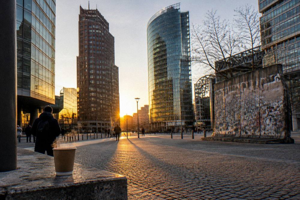 Cobblestone square in central Berlin with historic buildings at golden hour