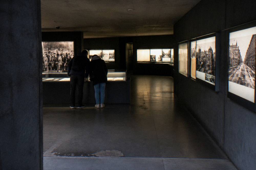 Underground exhibition hall with dim lighting and display panels along the walls