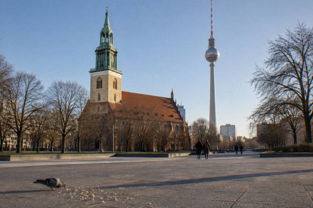 A wide city square with historic buildings and a crowd-free paved open space
