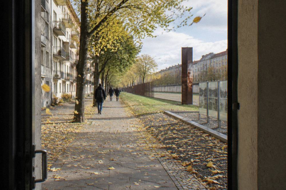 Tree lined residential street in Prenzlauer Berg with restored apartment facades