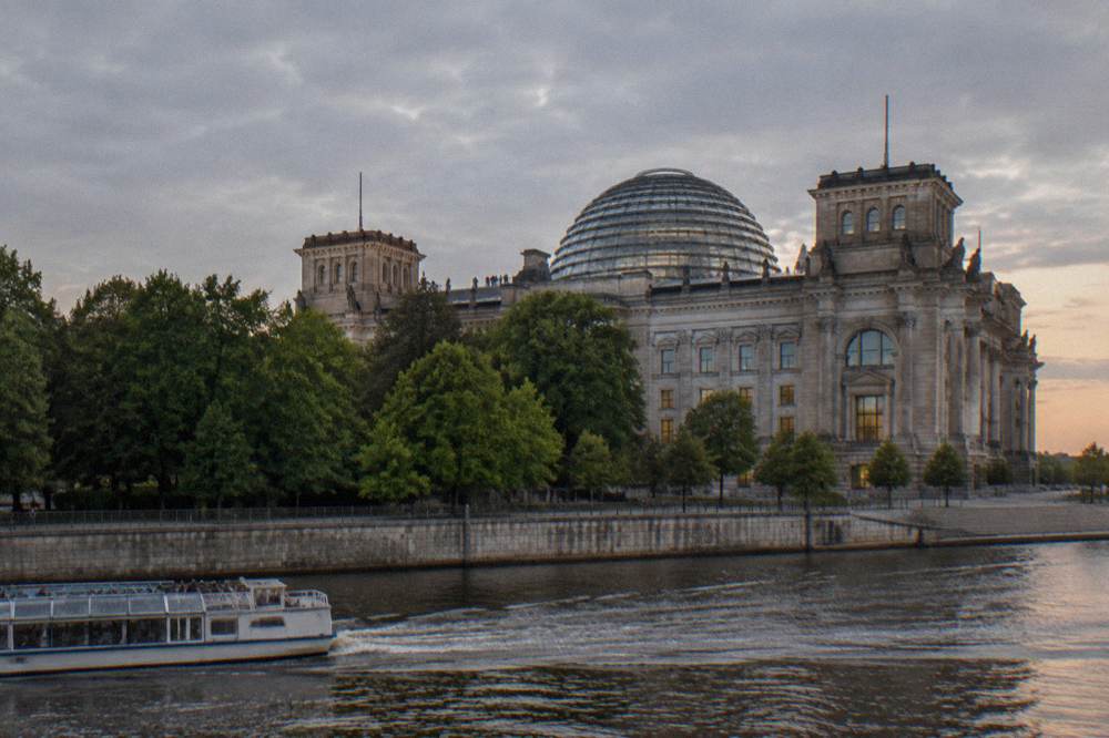 The Reichstag building seen from open ground with its dome visible above the facade