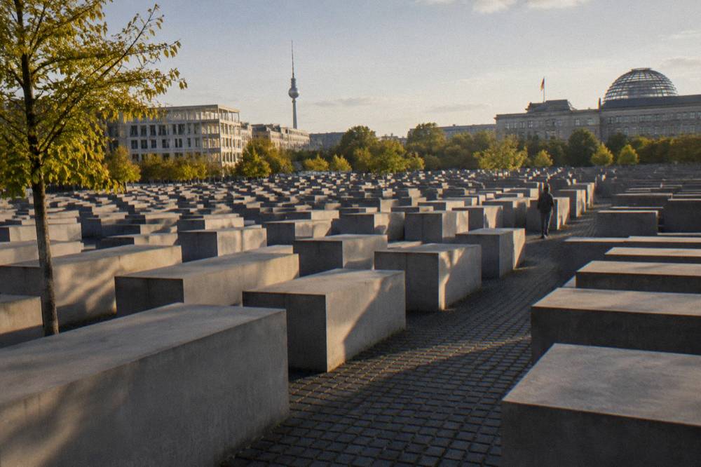 Rows of concrete stelae of the Memorial to the Murdered Jews of Europe between city streets