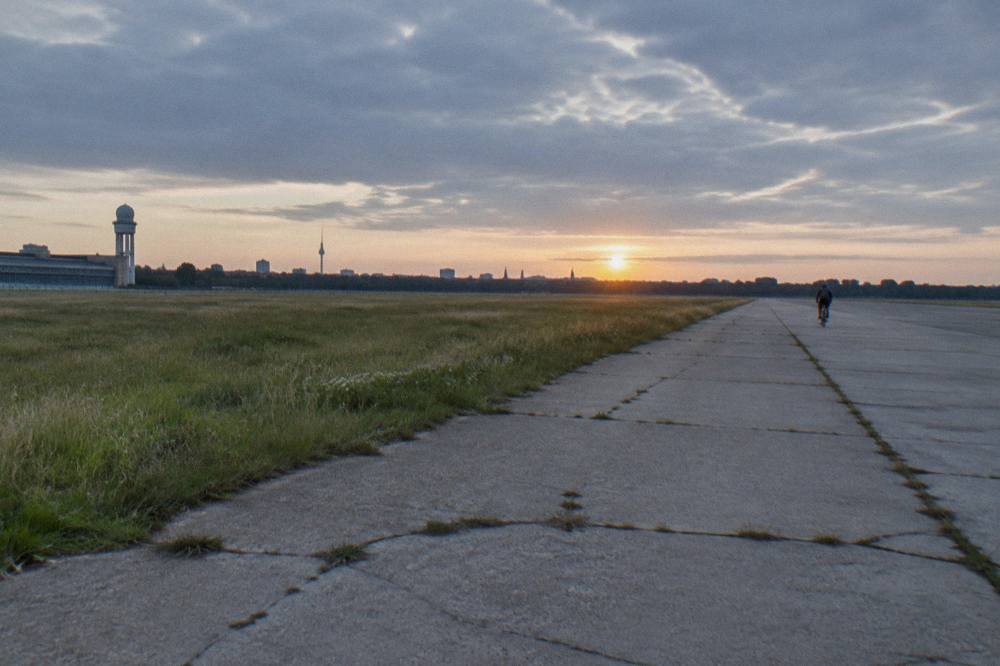 Empty concrete runway stretching into the distance at Tempelhofer Feld