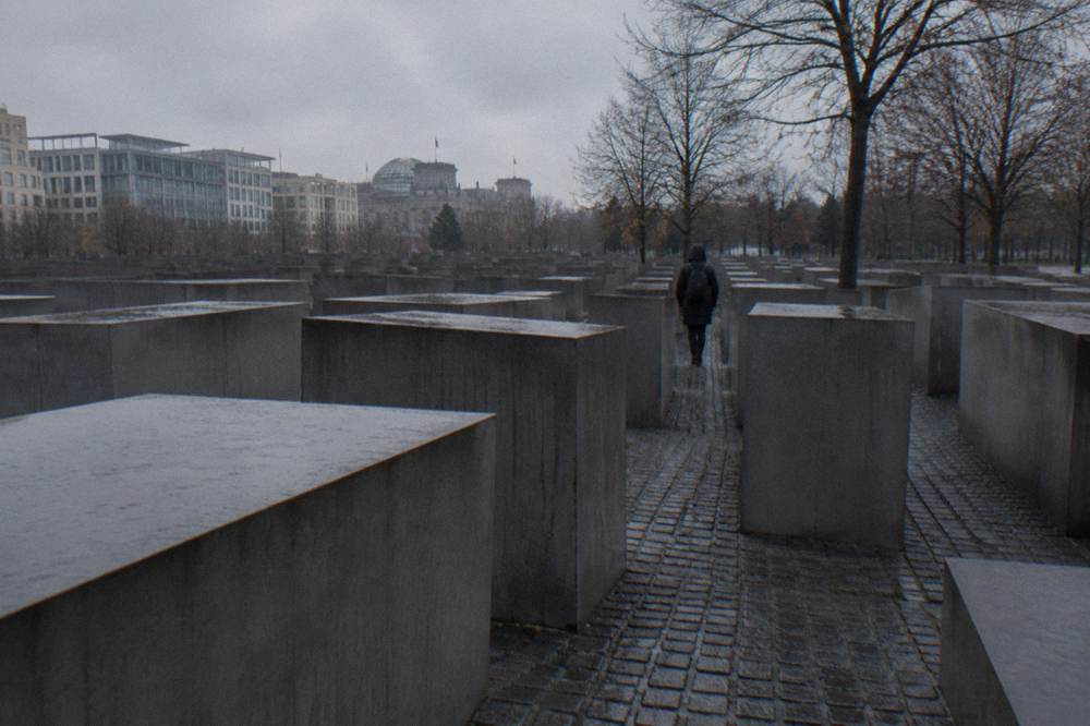 Rows of concrete stelae of different heights forming a memorial field